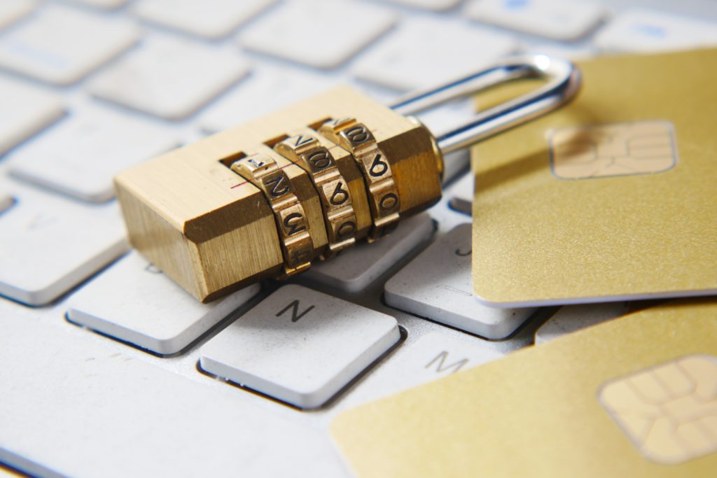 padlock on top of keyboard with bank cards